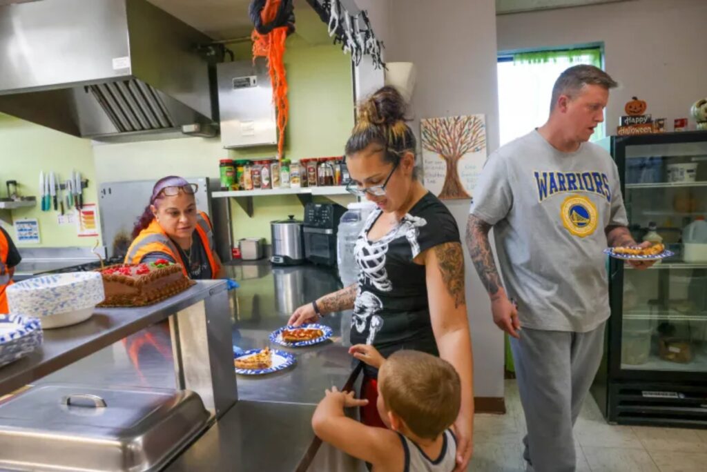 Family gets plates of food at dining counter