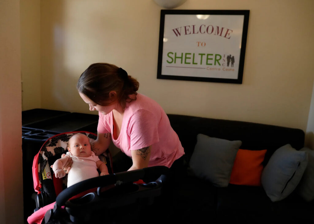 woman places baby into carseat